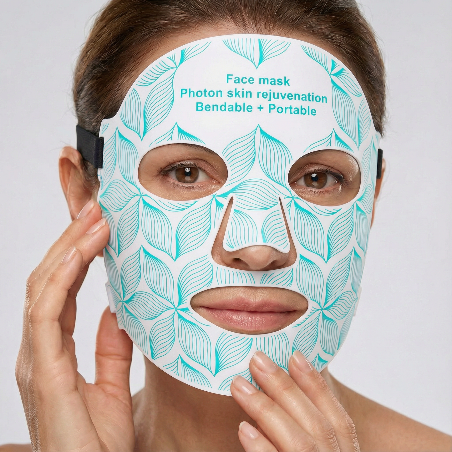 Woman wearing a face mask with leaf pattern and text on a white background